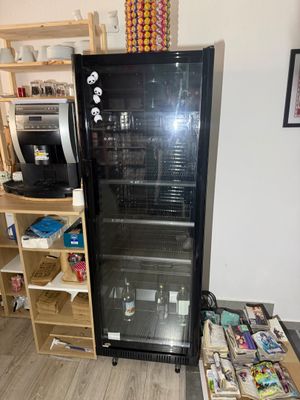 a refrigerator that is sitting in the corner of a room