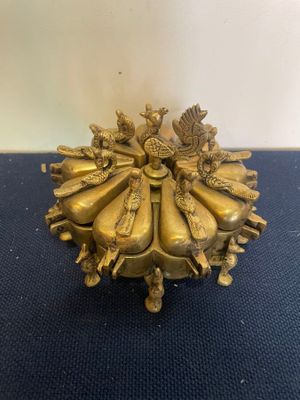 a gold plate with a group of people sitting on top of it