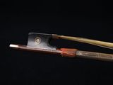 an image of a bow with a wooden handle on a black background