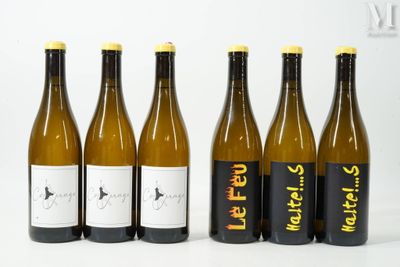 six bottles of wine are lined up in a row on a white surface