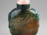 a small glass bottle with a rock inside of it
