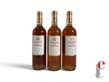three bottles of wine sitting next to each other on a white surface