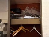 a closet with clothes and other items in it