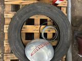 a tire that is sitting on a pallet next to some tools
