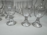 six wine glasses sitting on a table with a white table cloth