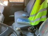 a yellow vest sitting on the seat of a bus