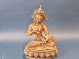 an image of a statue of a woman sitting on top of a table