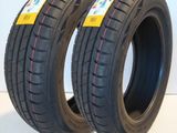 a pair of two tires on a white surface with a red stripe