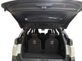 a trunk of a car with four luggage bags in it