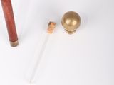 an old fashioned baseball bat and ball sitting on a white surface