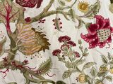 an image of a bed with a white and red floral comforter on it