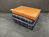 several books stacked on top of each other on a table