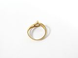 a close up of a gold ring on a white surface
