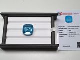 a blue diamond in a black box on a white surface