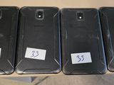 four cell phones are lined up in a row on a table