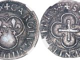 a close up of a coin with a cross on it