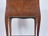 a small wooden table with a shelf on it