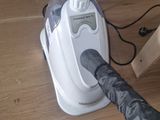a vacuum that is sitting on the floor with an umbrella on it