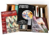 many books in a box that are sitting on a table