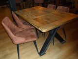 a wooden table with chairs around it on a hard wood floor