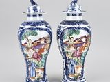 pair of chinese blue and white vases with figures on them