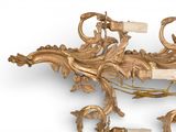 a gold wall sconce with a wine bottle on top of it