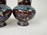 two vases that are sitting on a table