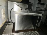 a silver oven sitting in the middle of a kitchen