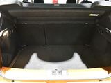 the back of a car with the trunk open and the seat folded down