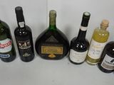 bottles of wine are lined up on a table in front of a red wall