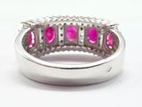 an image of a pink stone ring on a white surface