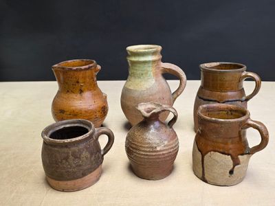 four different types of vases sitting on a table
