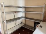 a metal shelving in the corner of a room