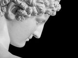 black and white photograph of a statue of a man with curly hair