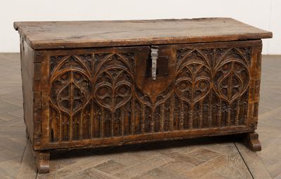 an old wooden chest sitting on top of a wooden floor next to a wall