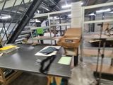 a room with a lot of tables and chairs in it