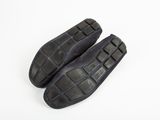 pair of black leather shoes on a white background