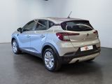 the rear end of a silver car in a showroom