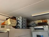 a room with a bunch of crates and a refrigerator