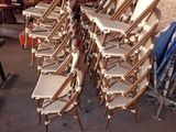 a lot of chairs that are stacked on top of each other