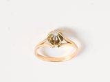 a close up of a diamond ring on a white surface