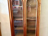 a wooden cabinet with a glass door in a room