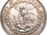 an image of a silver medal with an angel on top of it