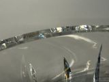 a glass bowl with a pair of scissors in it
