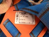 a person holding a blue and orange bag that has a tag on it
