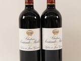 two bottles of red wine sitting next to each other on a white surface