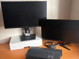deux écrans et un ordinateur portable posés côte à côte sur un bureau