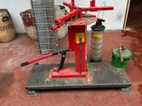 a red machine that is sitting on the ground