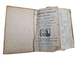 an old book opened to show a picture of a cat
