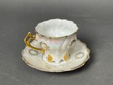 a cup and saucer on a saucer on a table